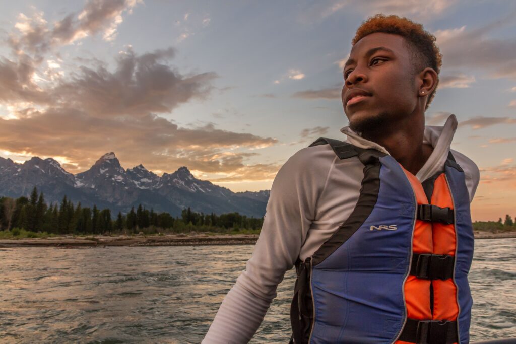 A participant from the Grand Adventure enjoys an evening on the Snake River in Grand Teton National Park.