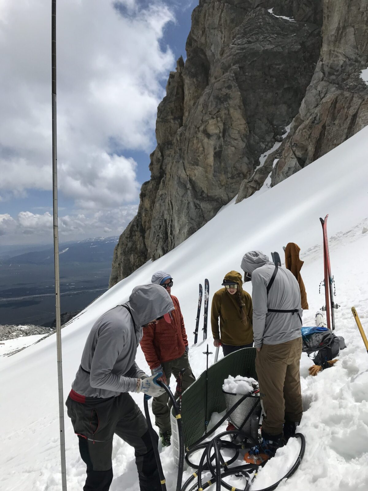 A team of park scientists takes ice depth measurements on the Middle Teton Glacier.