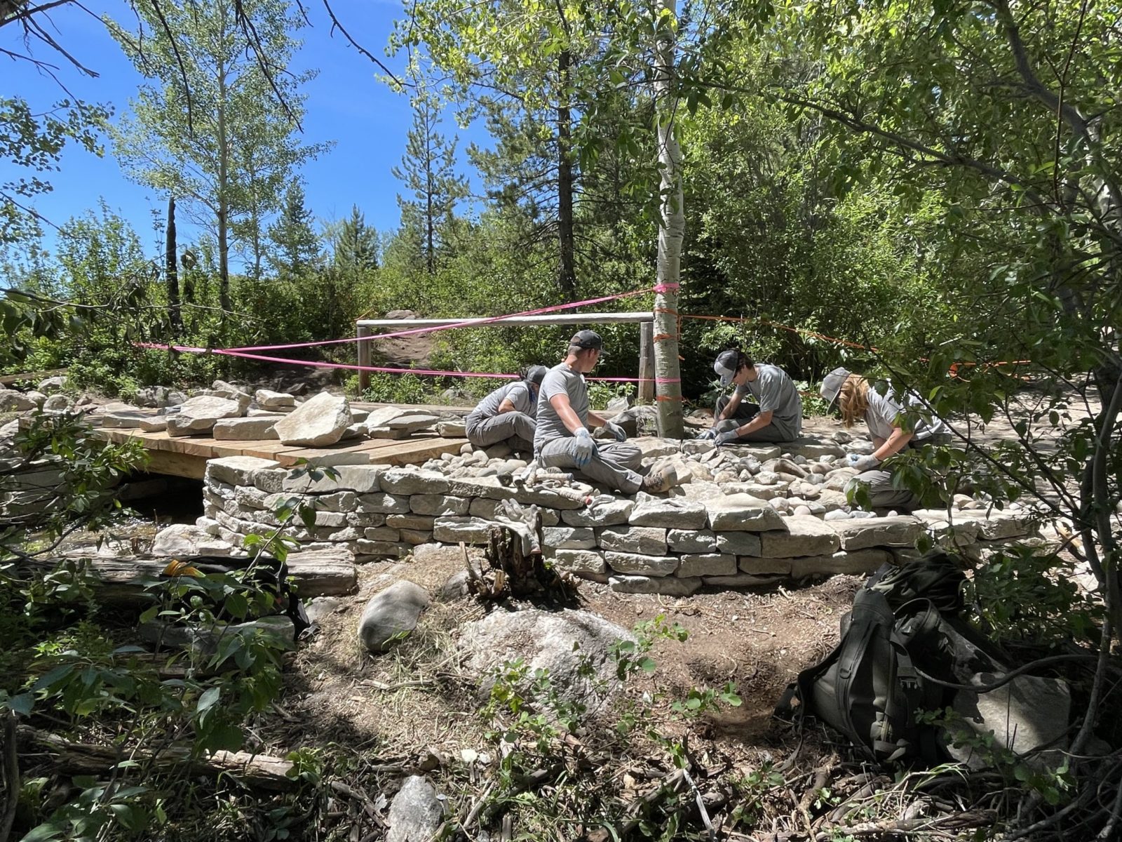 YCP employing drystone masonry techniques on the appraoches to the Taggart Lake corrals stock bridge.