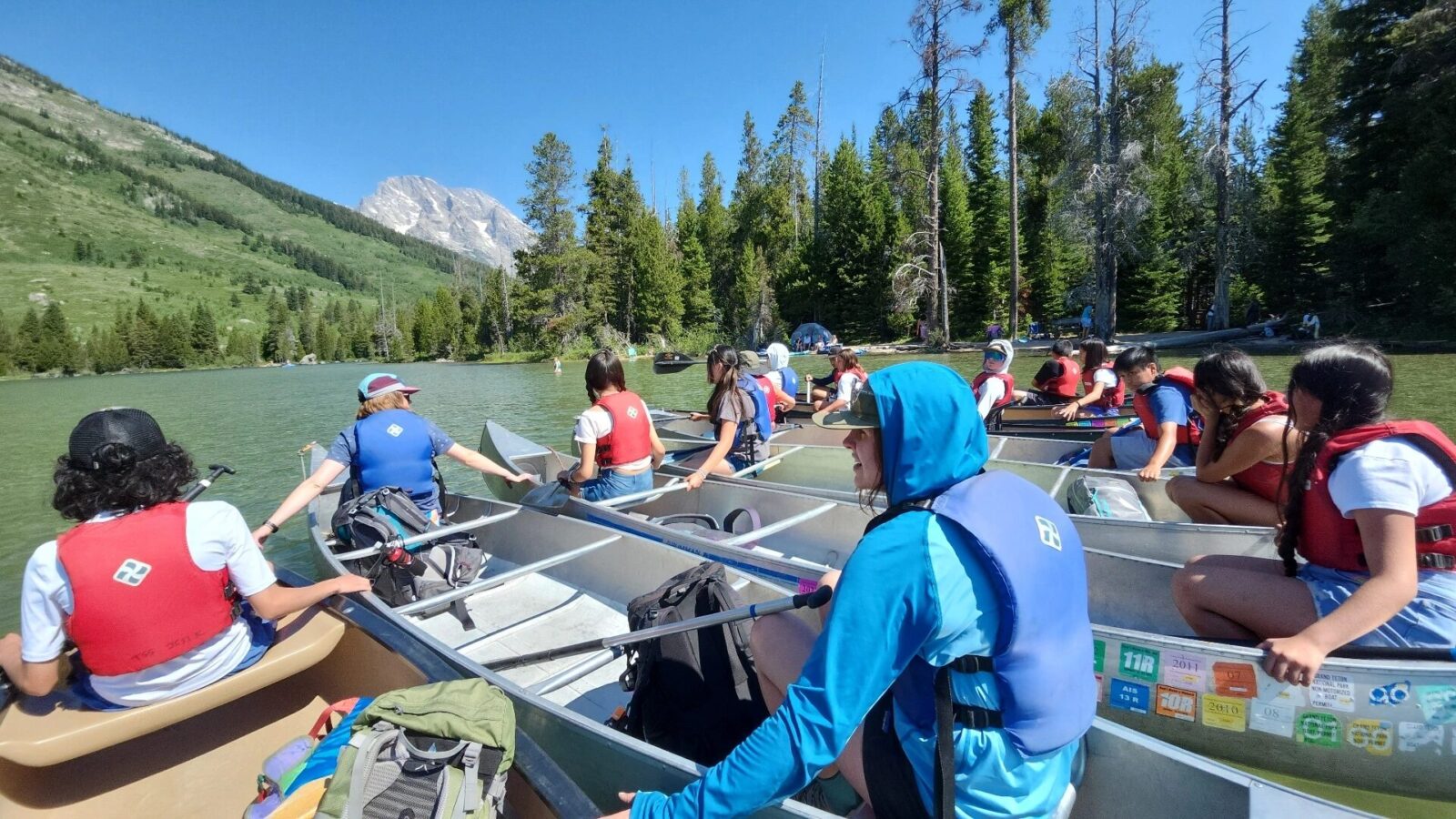 PV MS '24 Canoe Day Clear skies shine overhead as the Pura Vida program canoe on String Lake.
