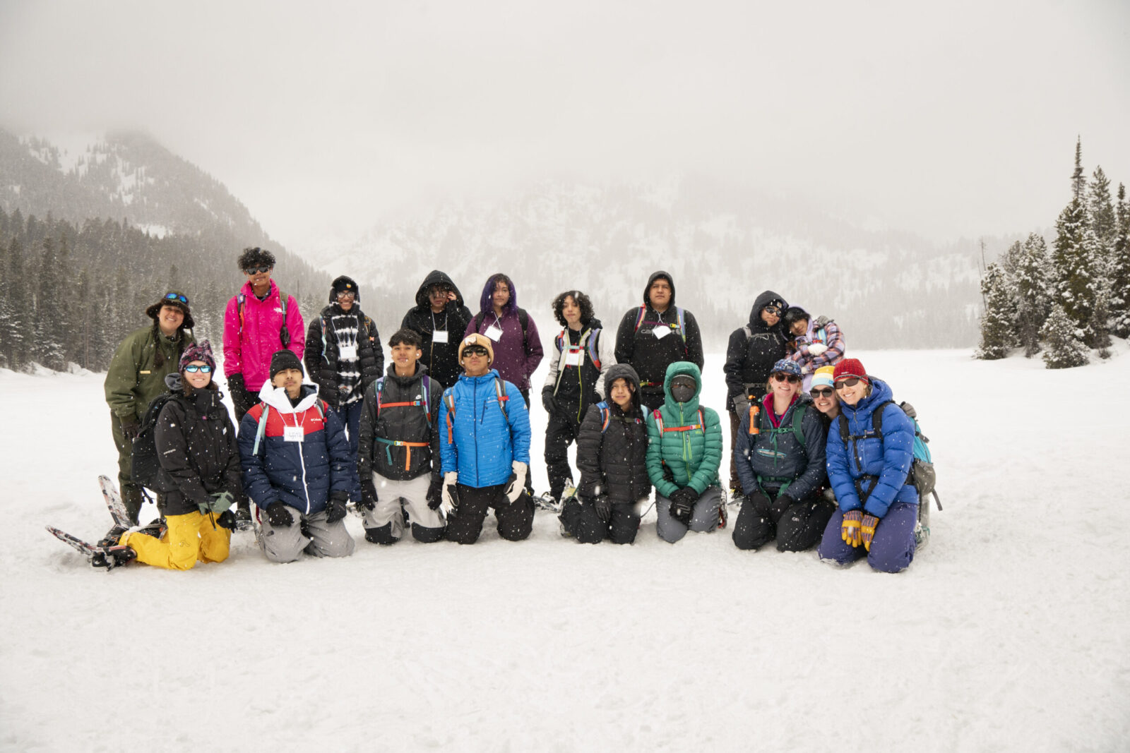 Participants of the Pura Vida program pose with members of Grand Teton's education team after snowshoeing to Taggart Lake.