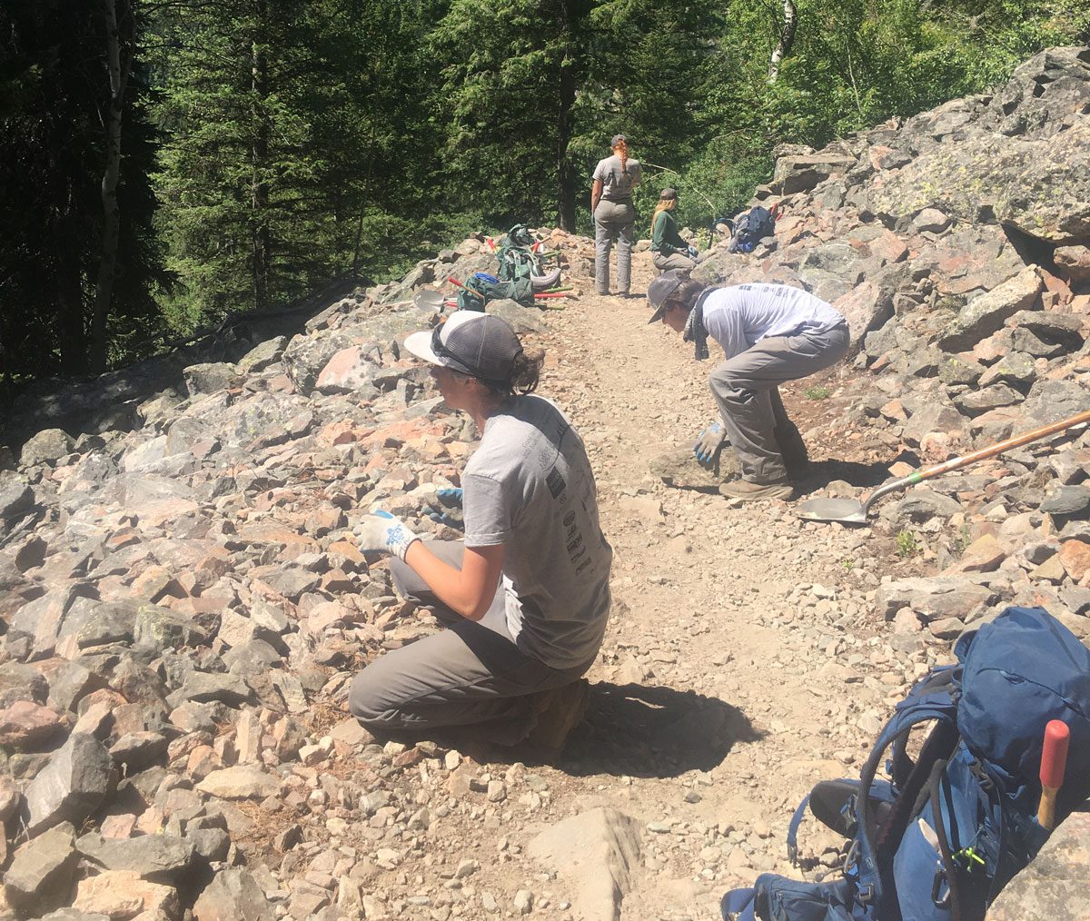 Crew members clear rocks from the Death Canyon trail.